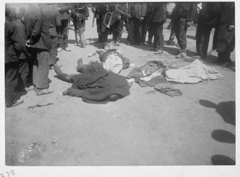 Martyred soldiers lying in the street, covered with coats, surrounded by soldiers and people, in Istanbul, Türkiye, April 1909 (Photo via Gertrude Bell)