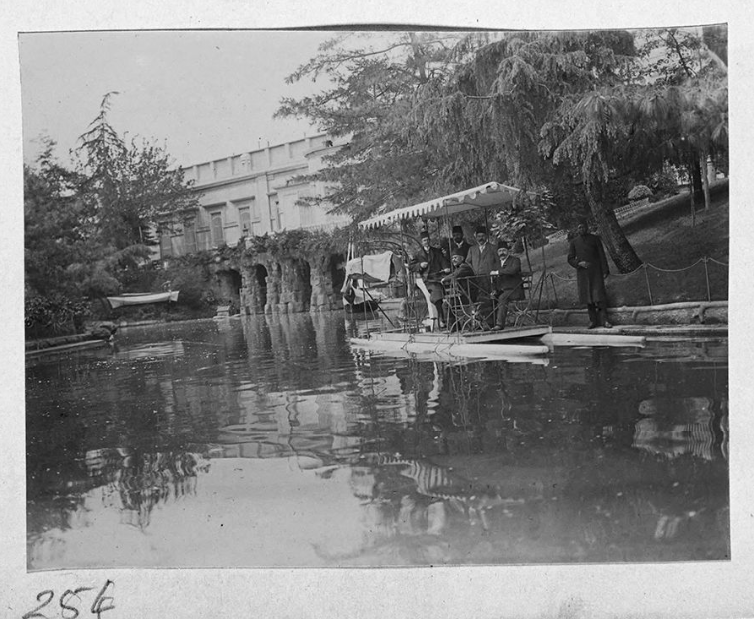 Greek tourists in a boat on the serpentine pond. Yildiz - hillside summer palace with parkland and chalet kiosks, Yildiz Sarayi, in Istanbul, Türkiye, July, 1909 (Photo via Gertrude Bell)