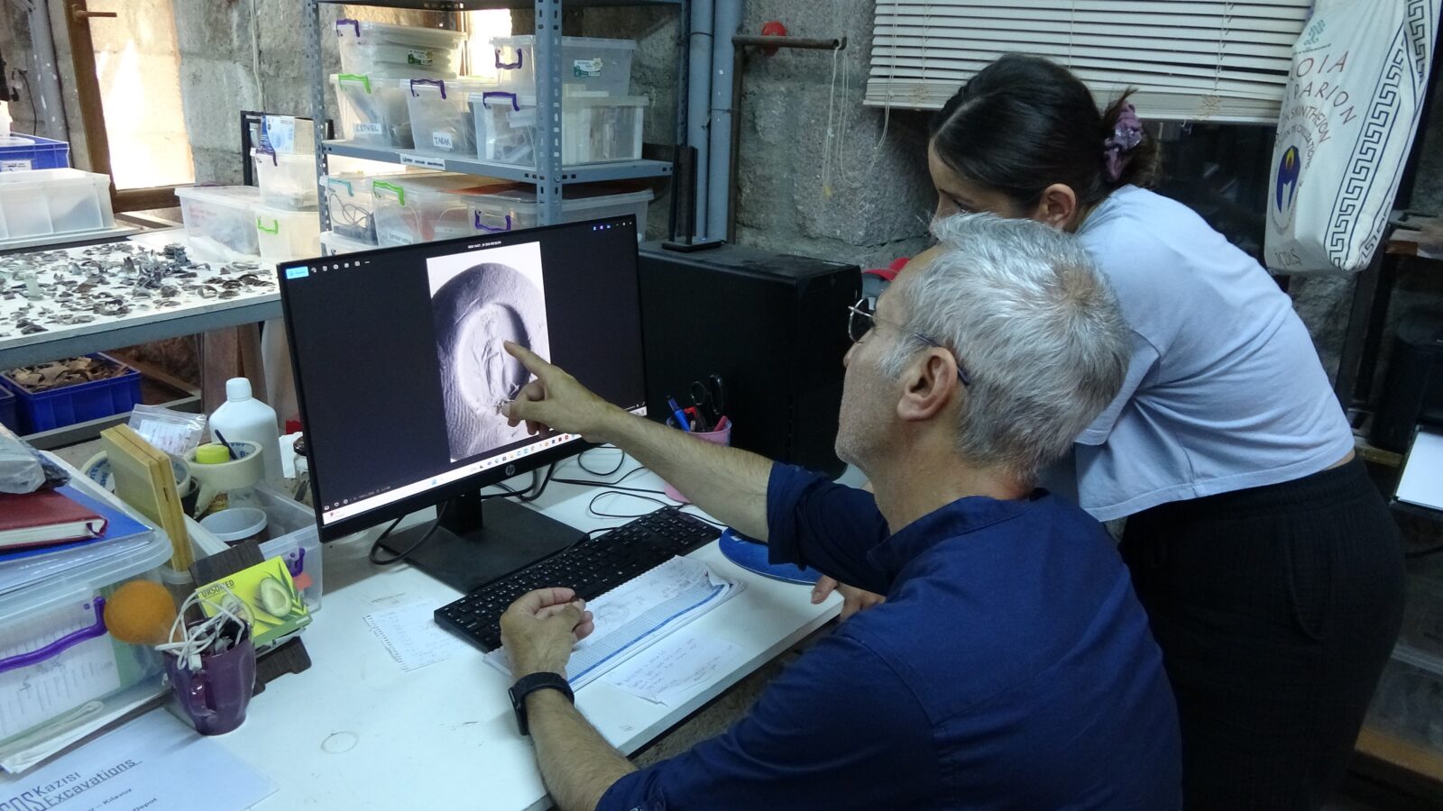 Professor Nurettin Arslan, Head of Assos Excavations, examines the ringstone, Canakkeale, Türkiye August 30, 2024 (IHA Photo)