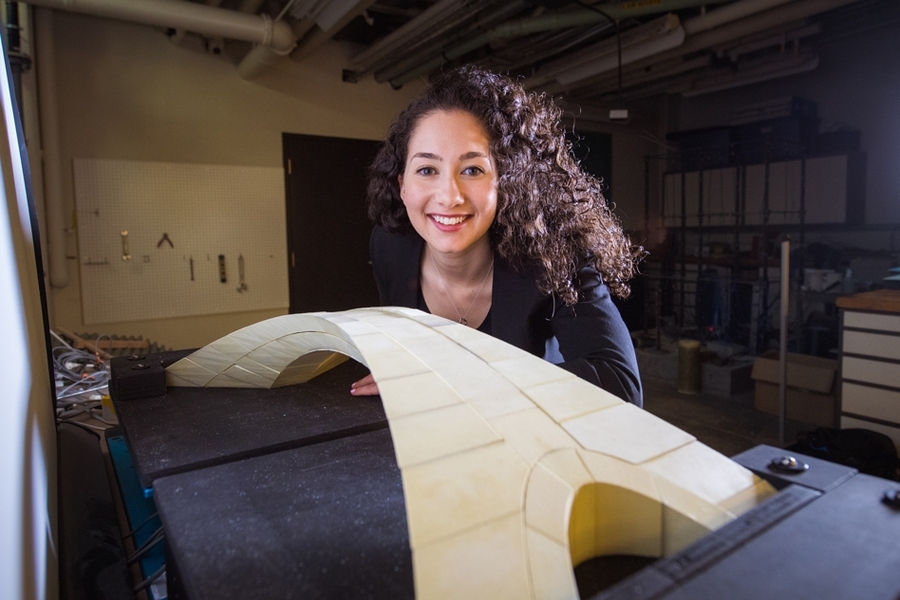 Karly Bast with her scale model of Leonardo da Vinci's bridge design Gretchen Ertl, October 9, 2029. (Photo via MIT news)