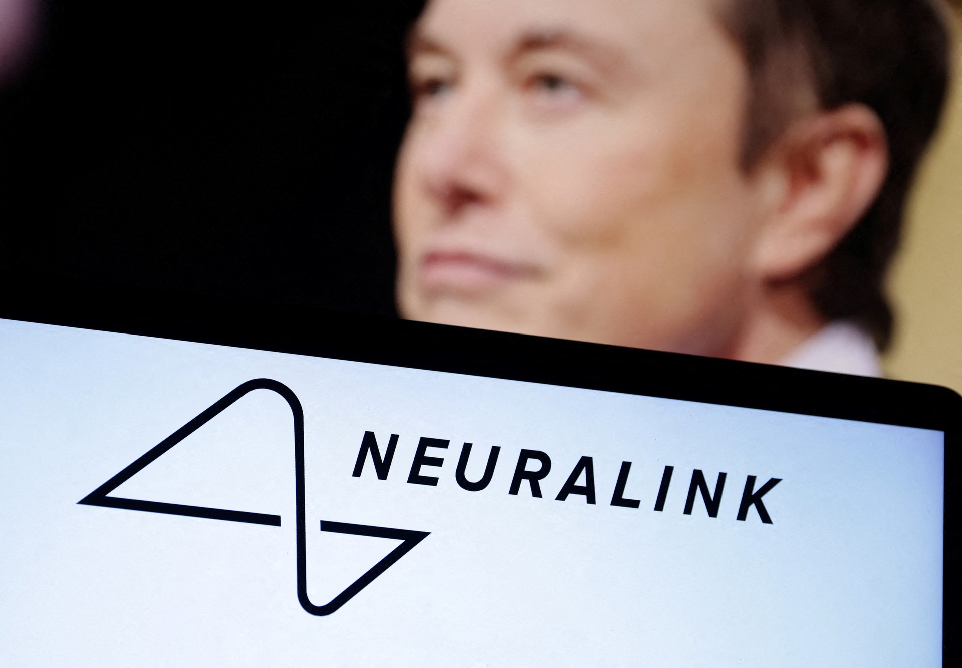 Neuralink logo and Elon Musk photo are seen in this illustration taken, December 19, 2022. (Photo via Reuters by Dado Ruvic)