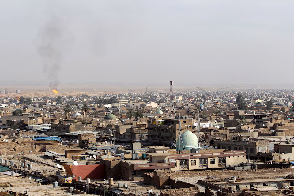 A view of the city of Kirkuk shows a flame from an oilfield in the distance, October 25, 2010. (Photo via Reuters by Saad Shalash)