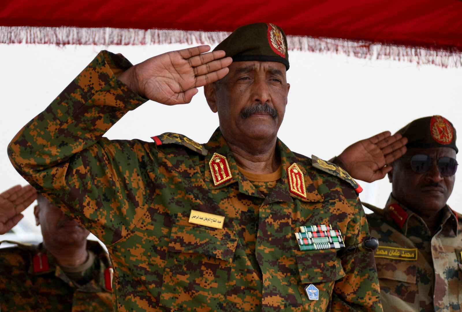 Sudan's General Abdel Fattah al-Burhan salutes as he listens to the national anthem after landing in the military airport of Port Sudan on his first trip away following the crisis in Sudan's capital Khartoum since an internal conflict broke out, in the city of Port Sudan, Sudan, August 27, 2023. REUTERS/Ibrahim Mohammed Ishak/File PhotoFILE PHOTO: Lieutenant General Mohamed Hamdan Dagalo, deputy head of the military council and head of paramilitary Rapid Support Forces (RSF), greets his supporters as he arrives at a meeting in Aprag village, 60 kilometers away from Khartoum, Sudan, June 22, 2019. REUTERS/Umit Bektas/File Photo