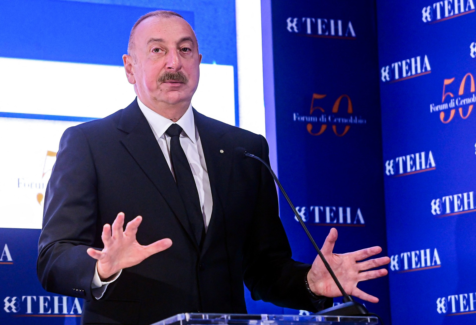 Azerbaijan's President Ilham Aliyev gestures as he addresses the audience on the opening day of the 50th edition of The European House-Ambrossetti forum, called 