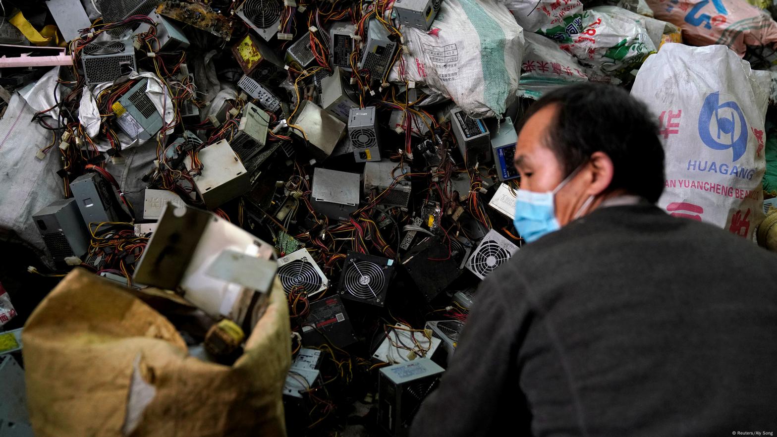 Electronic trash with one person with mask can be seen. (Reuters/Aly Song) 