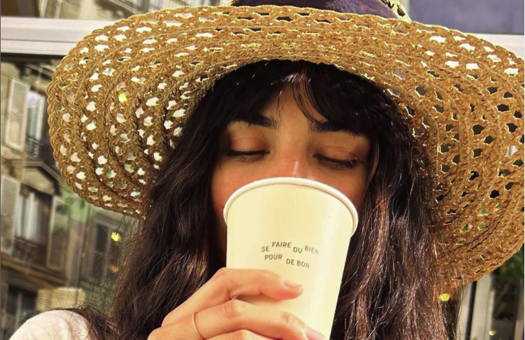 Tuba Buyukustun looks effortlessly stylish with a chic straw hat, holding a paper cup in a casual yet beautiful pose, September 04, 2024. (Photo via Instagram / tubabustun.official)