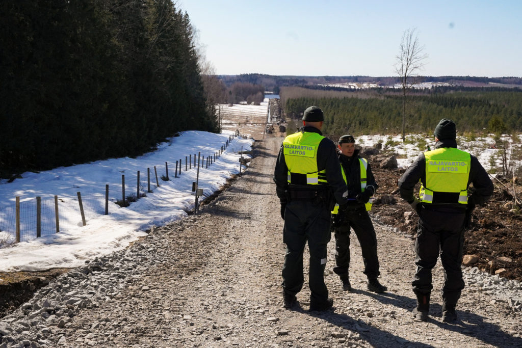 Finnish border guards stand near border fence with Russia in Pelkola, Finland April 14, 2023. (Reuters/Janis Laizans)