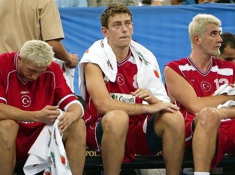 Hidayet Turkoglu (L) Asim Pars (C) and Huseyin Besok (R) sit on the bench 29 August, 2002 during their loss to Puerto Rico in preliminary round one of the 2002 Men's FIBA World Basketball Championships at the RCA Dome in Indianapolis, United States. (Getty Images)