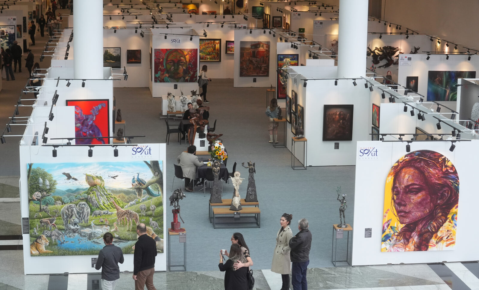 People visit the ArtNova Art Fair at ATO Congresium, where works of architecture, graphic design, painting, sculpture, and decorative arts by approximately 900 artists are on display in Ankara, Türkiye, Oct. 17, 2024. (AA Photo)