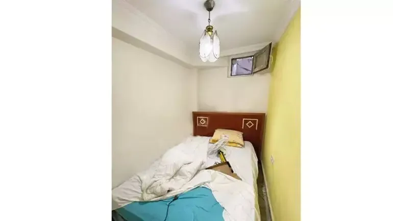 A small bedroom with a narrow window and a damaged bed in a basement-level apartment in Istanbul, Türkiye, October 13, 2024. (Photo via Instagram)