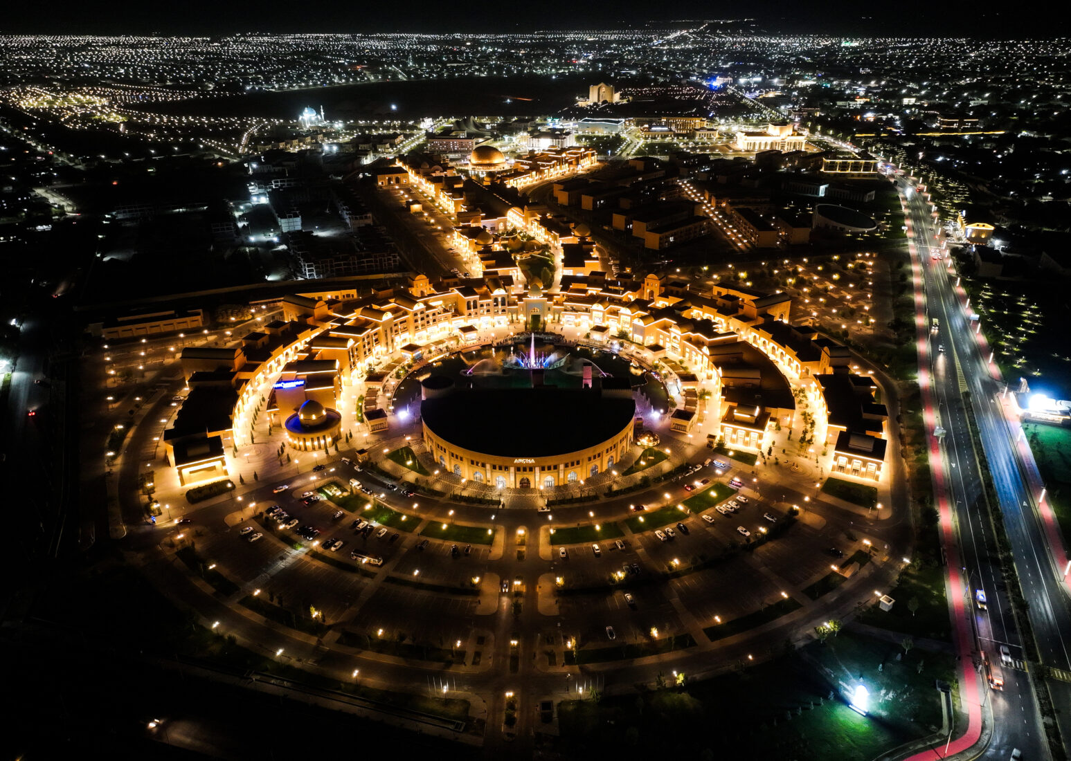 An aerial view showcasing the city illuminated in vibrant lights, highlighting its status as the 