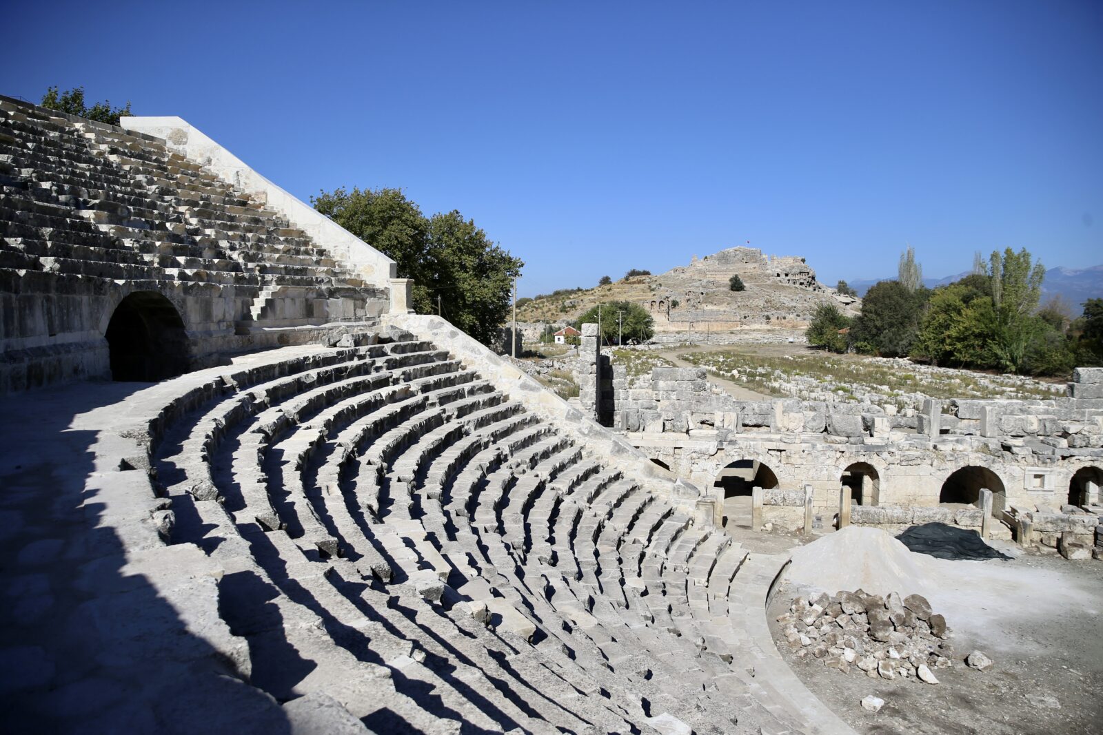 A view of the assembly building complex, two baths, and the Temple of Kronos in the ancient city of Tlos, located in Seydikemer district of Mugla, Türkiye reveals the ongoing restoration efforts to revive these structures, October 11, 2024 (AA Photo)A view of the assembly building complex, two baths, and the Temple of Kronos in the ancient city of Tlos, located in Seydikemer district of Mugla, Türkiye reveals the ongoing restoration efforts to revive these structures, October 11, 2024 (AA Photo)