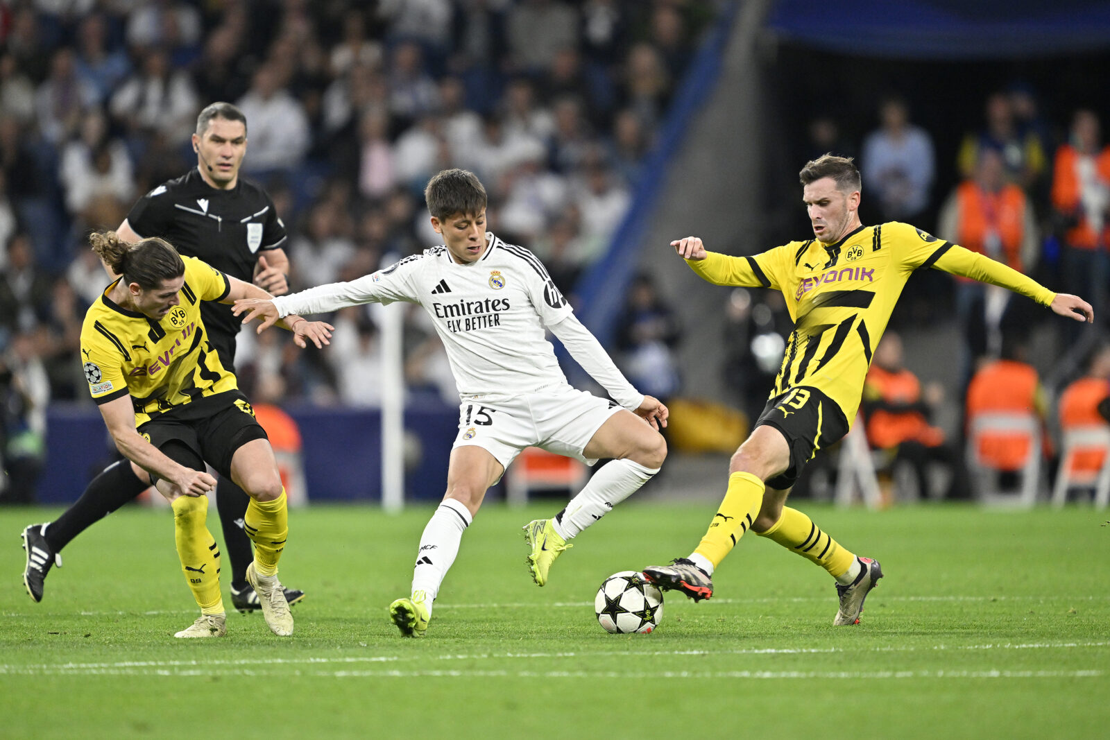 Real Madrid's Arda Guler (brought into the game in the 89th minute) competes against Marcel Sabitzer and Pascal Gross of Borussia Dortmund in Madrid, Spain, October 22, 2024. (AA Photo)