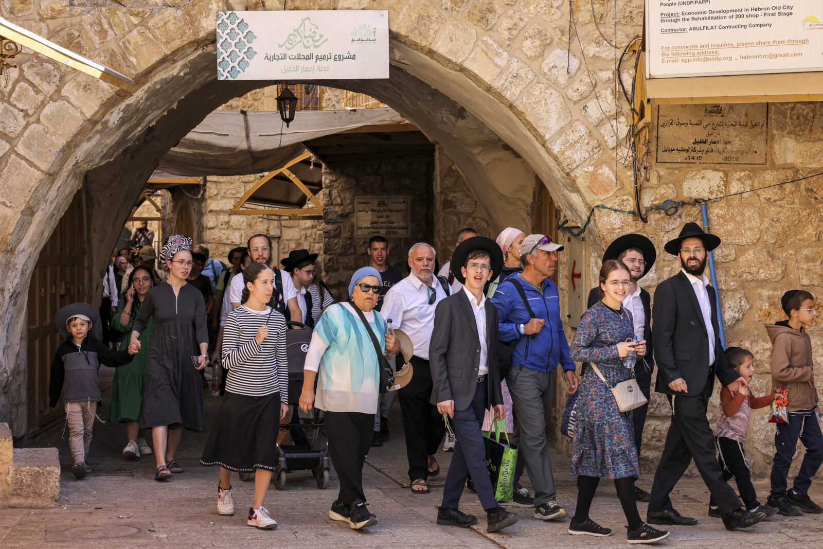 Israeli settlers walk in a guided tour of the old market in the Palestinian part of the old city of Hebron in the occupied West Bank during the Jewish holiday of Sukkot, or the Feast of the Tabernacles, Oct. 22, 2024. (AFP Photo)