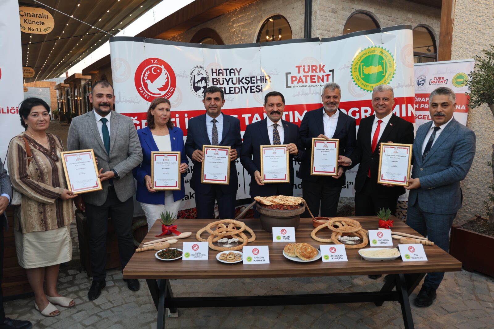 Officials present certificates recognizing Hatay's six regional dishes with geographical indication status, Hatay, Türkiye, Oct. 9, 2024. (IHA Photo)