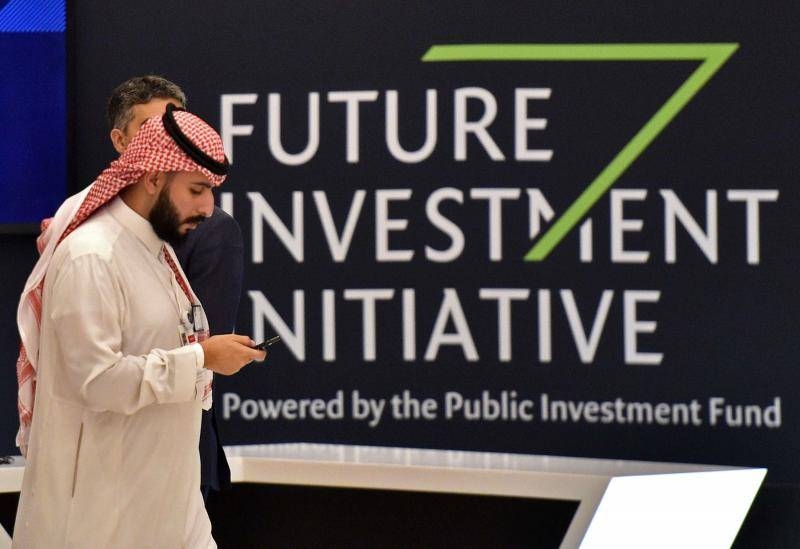 A man walks past a sign at the start of the Future Investment Initiative (FII) in Riyadh, on Oct.23,2019. (AFP Photo)