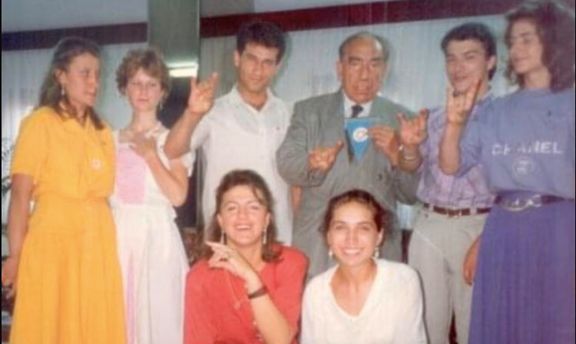 Alparslan Turkes gives the bozkurt salute with young people. (Source Unknown)