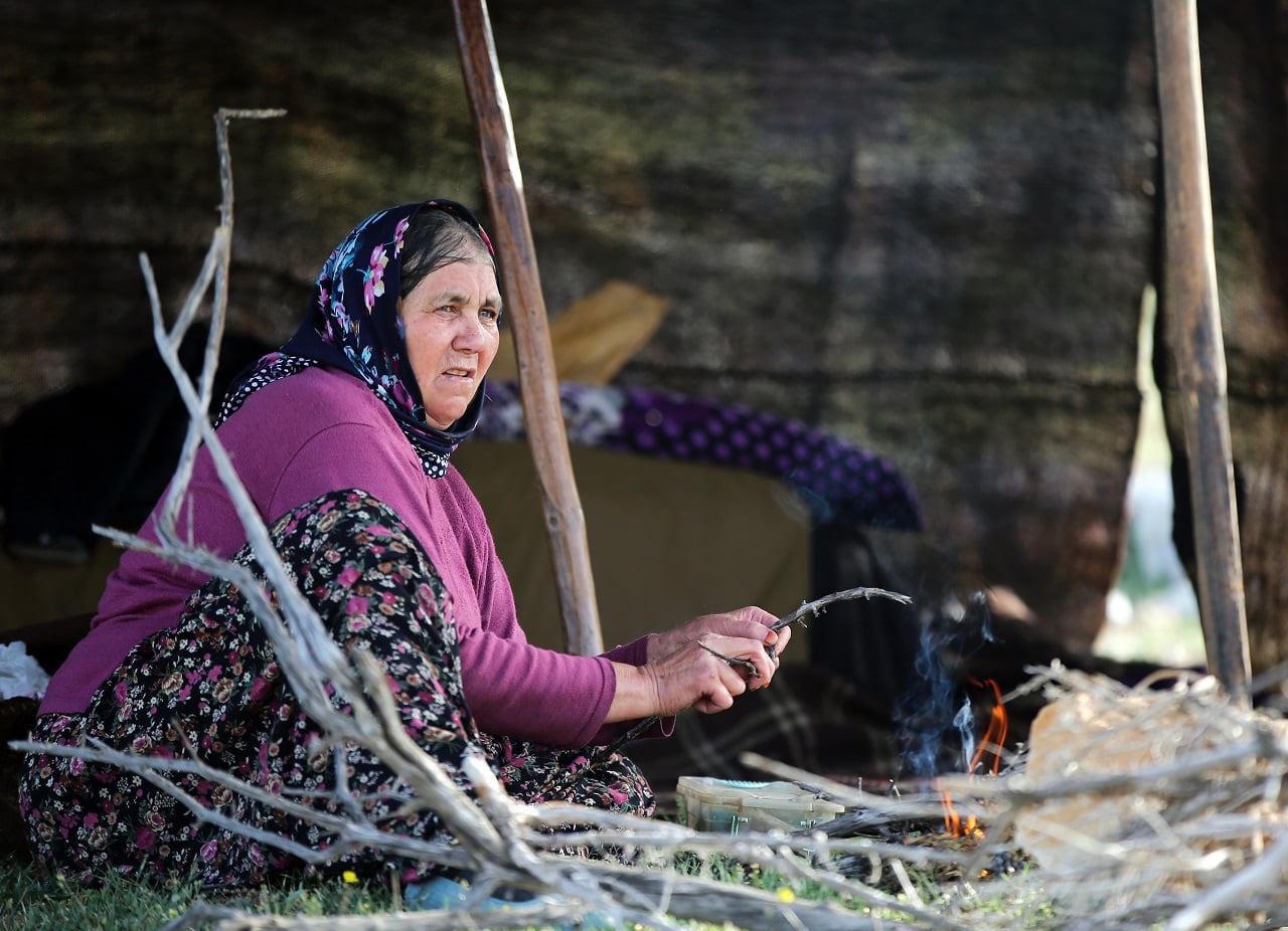 A Sarikecili Yoruk woman prepares a fire outside her tent in Konya, Türkiye, May 6, 2021. (Photo via Facebook / @Guzel Konya)