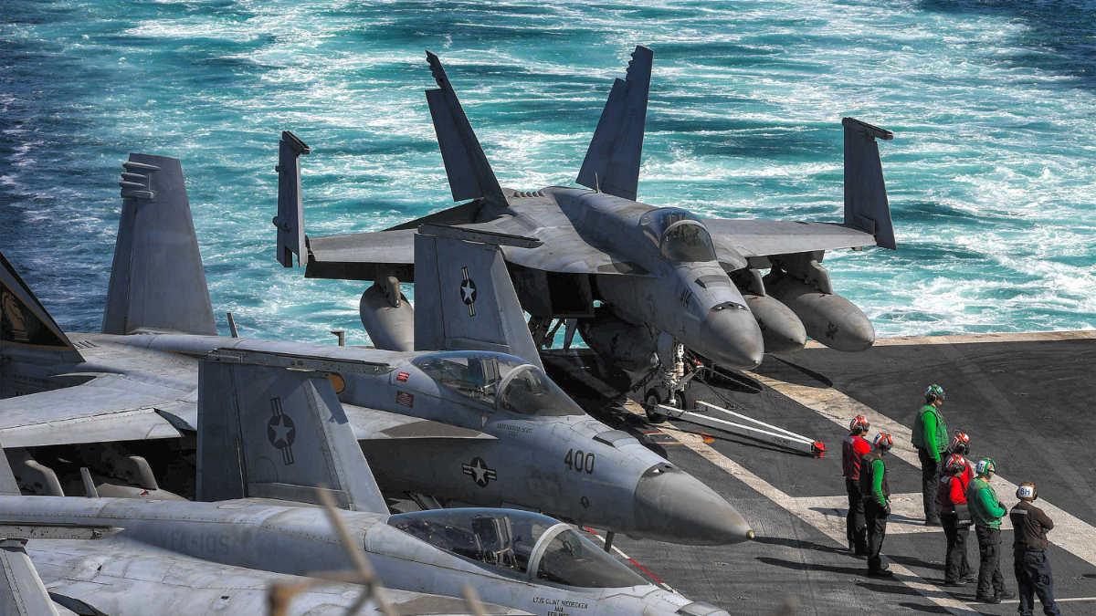 US Navy F/A-18 Hornet multirole combat aircraft on the deck of the aircraft carrier USS Dwight D Eisenhower transiting the Strait of Hormuz on 26 November 2023 (US Department of Defence handout/AFP) 