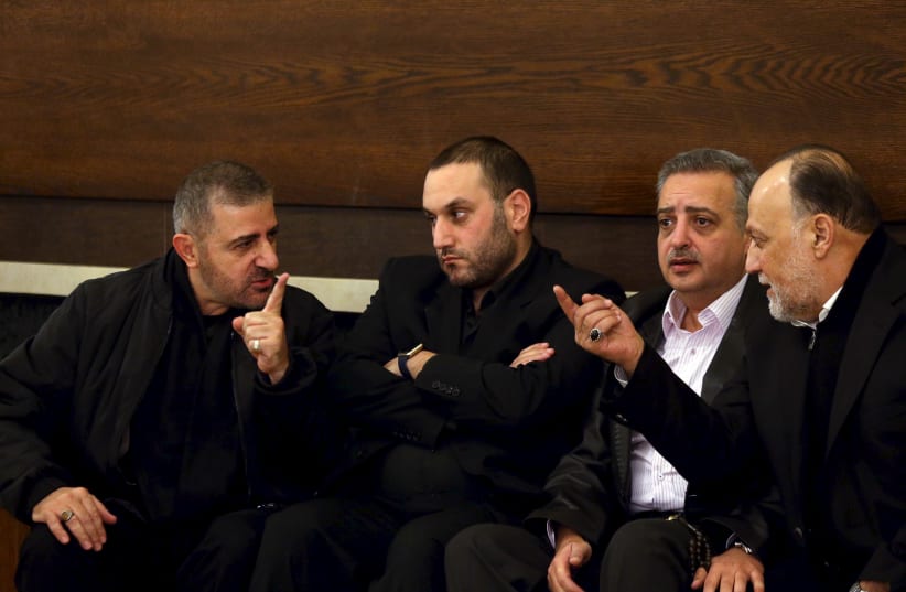 Hezbollah official Wafiq Safa (L) talks Hezbollah parliament member Ali Ammar (R) as Druze Democratic Party chief Talal Arslan (2nd R) looks on after offering their condolences to Bassam Qantar (2nd L), the brother of Lebanese Hezbollah militant leader Samir Qantar who was killed in an Israeli air strike in Damascus early on Sunday, in Beirut's southern suburbs, Lebanon December 20, 2015 (Reuters/Hasan Shaaban)