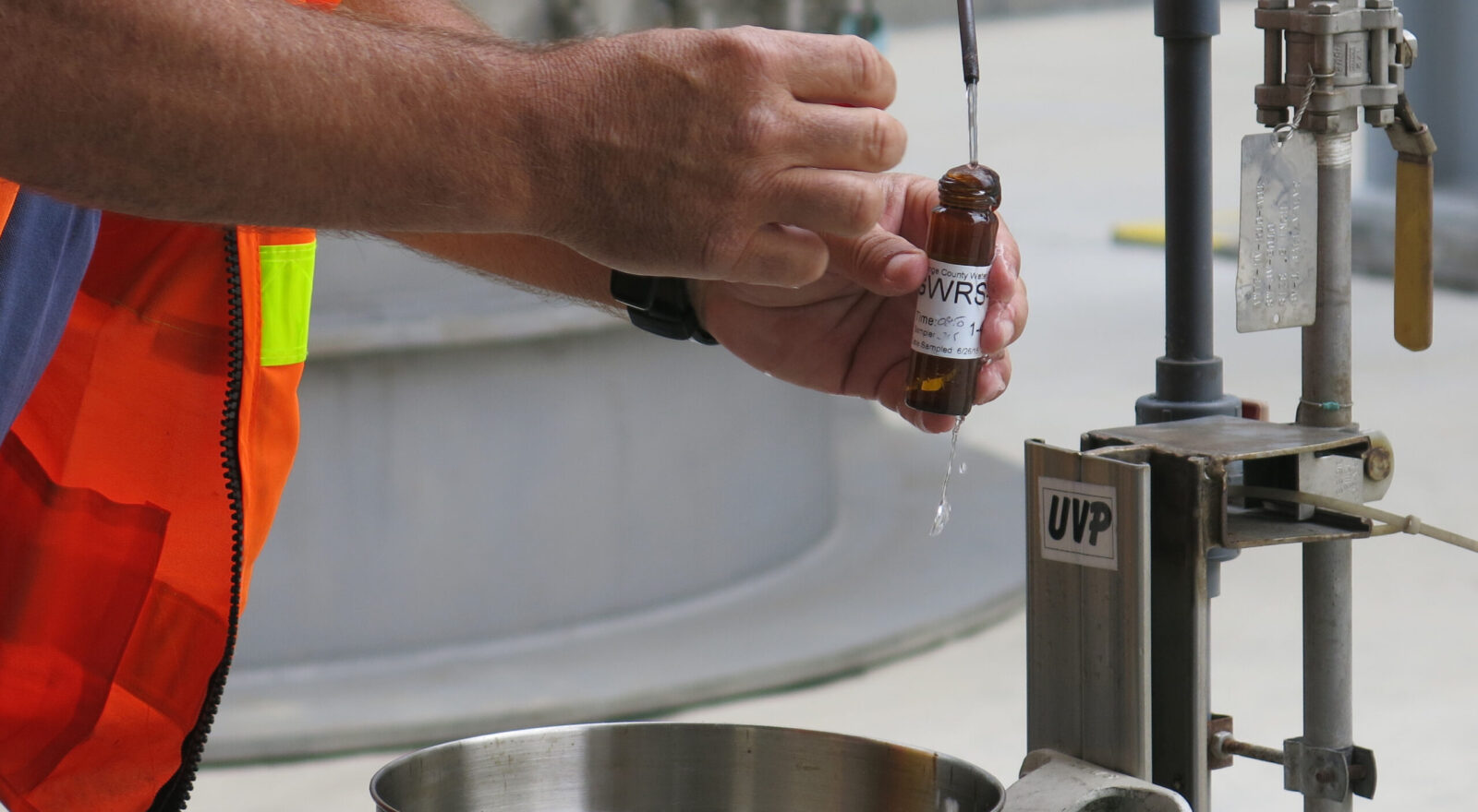 An Orange County Water District worker draws a sample of water produced by the groundwater replenishment system, which purifies treated wastewater for release into the groundwater basin in Fountain Valley, Calif., June 26, 2015. (Getty Images)
