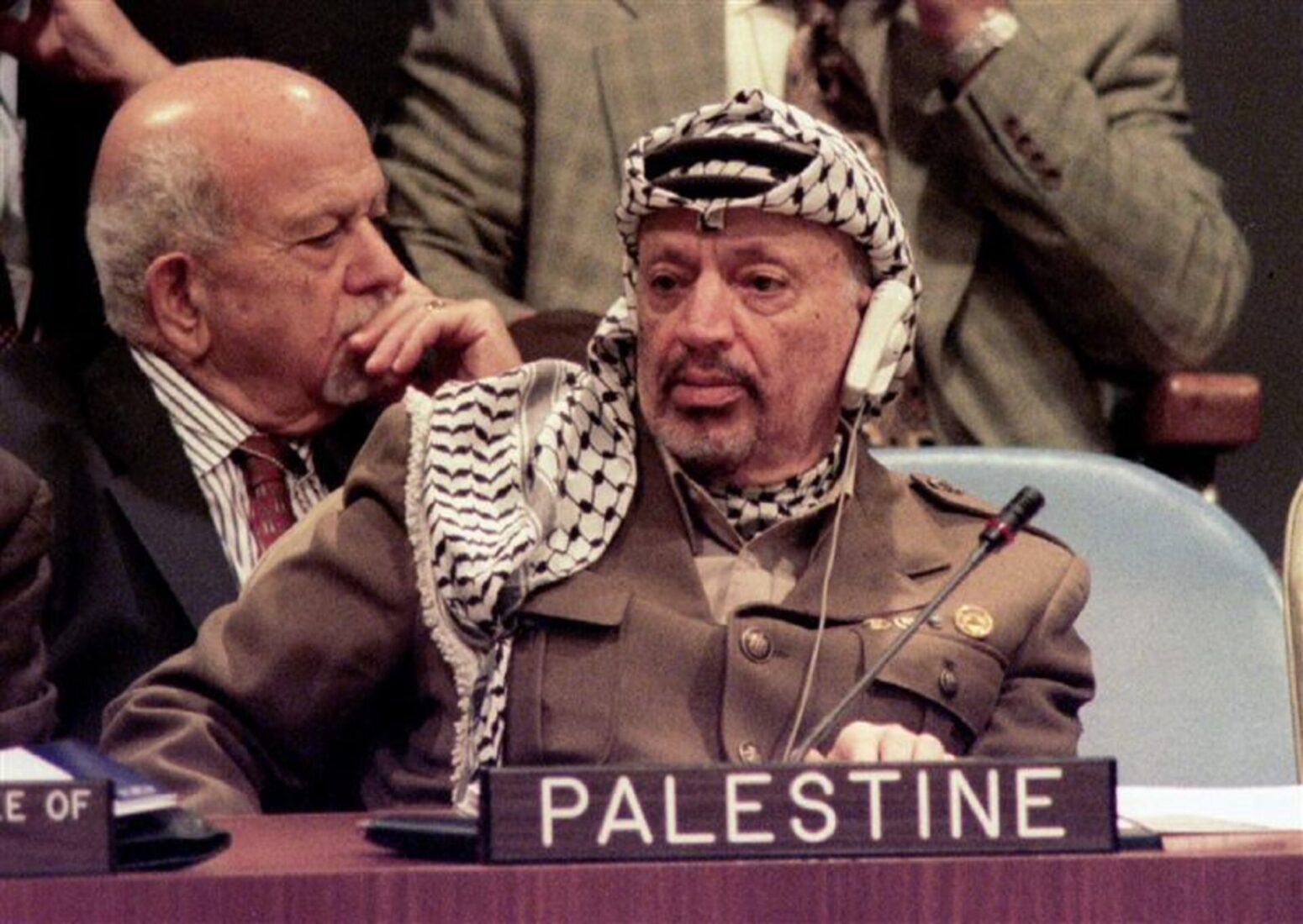 Chairman of the Palestine Liberation Organization Yasser Arafat and a member of the Palestinian delegation (L), listen as Israeli Prime Minister Yitshak-Rabin addresses the United Nations General Assembly October 24, 1995 (Reuters Photo)