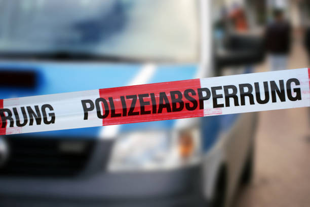 Police cordon tape with a police car in the background. (iStock)