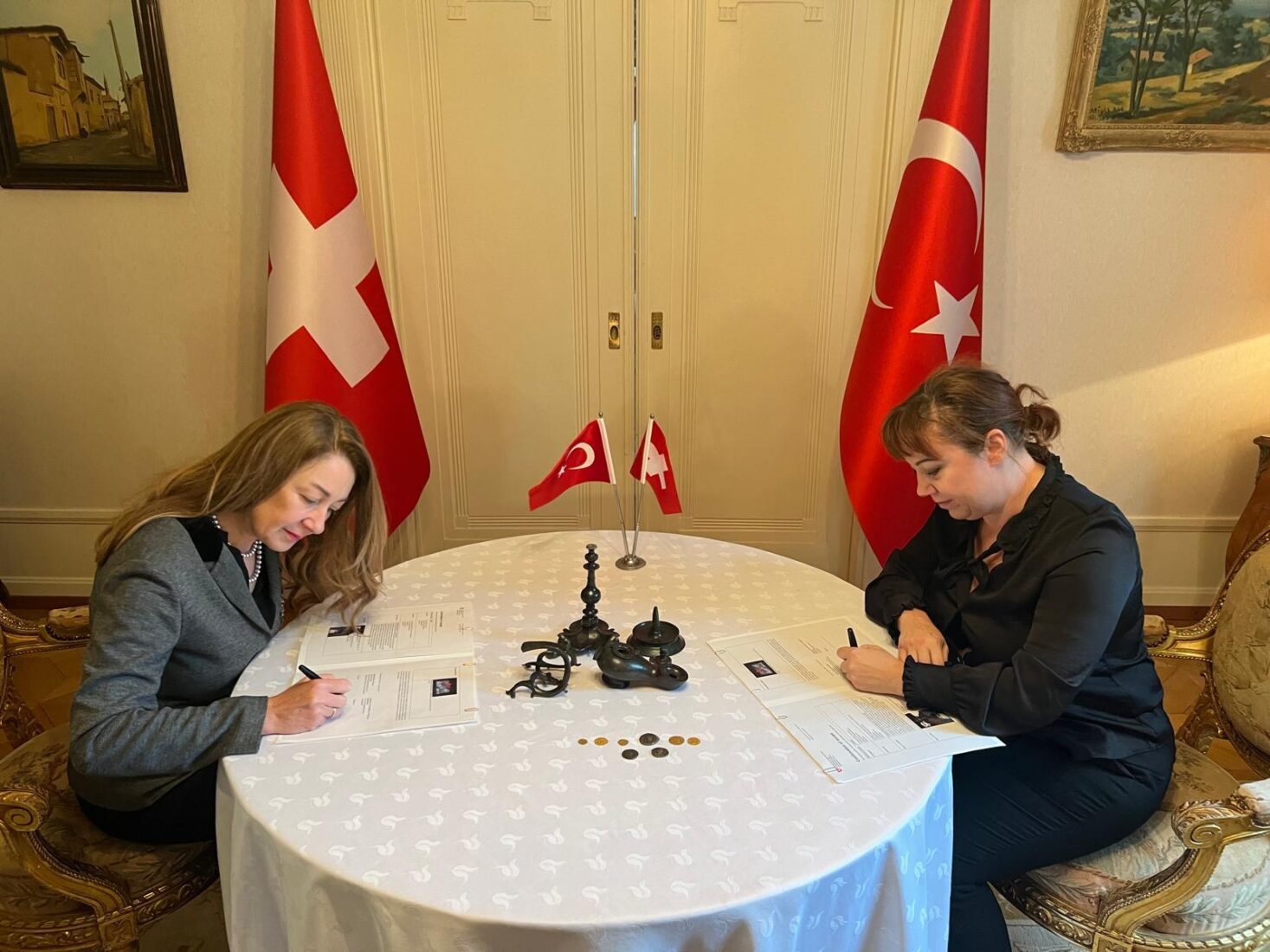 An oil lamp, seven coins, and one gold medallion dating from the fourth to seventh centuries A.D., seized in various investigations in Switzerland, were returned to Türkiye, Nov. 1, 2024. (AA Photo)