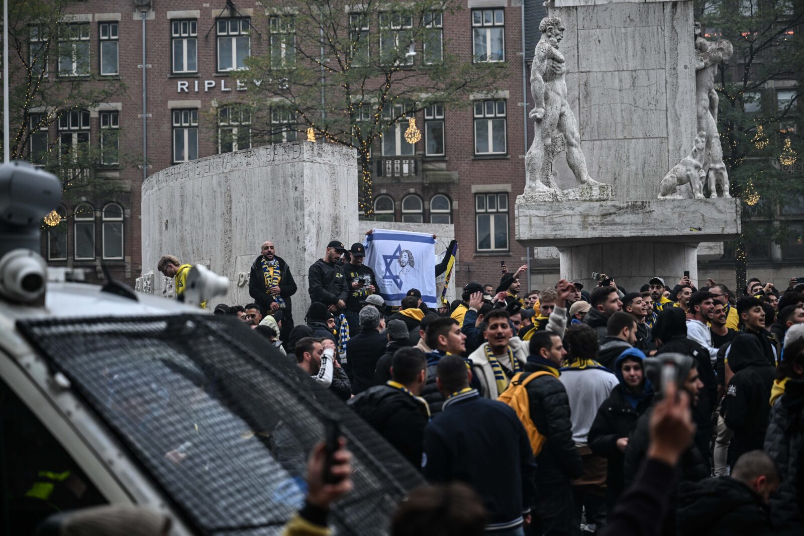 AMSTERDAM, NETHERLANDS - NOVEMBER 7: Fans of Maccabi Tel Aviv stage a pro-Israel demonstration at the Dam Square, lighting up flares and chanting slogans ahead of the UEFA Europa League match between Maccabi Tel Aviv and Ajax in Amsterdam, Netherlands on November 07, 2024. Maccabi fans clashed with pro-Palestinian citizens and ripped off Palestinian flags hung on the streets. In the lead-up to the Ajax vs Maccabi Tel Aviv match, several areas of Amsterdam have been designated as security risk zones. ( Mouneb Taim - Anadolu Agency )<img src=