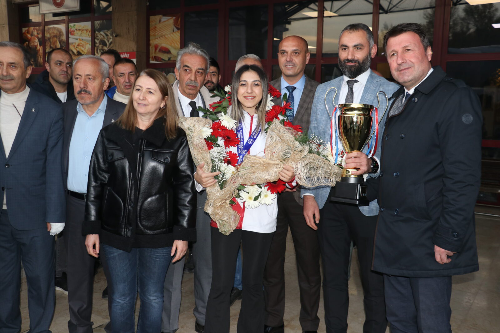 A welcome ceremony was held at Kastamonu Bus Terminal for Asuman Ciglioglu, who returned to her hometown after winning a gold medal at the European Kickboxing Championship in Greece, Kastamonu, Türkiye, Nov. 11, 2024. (AA Photo)