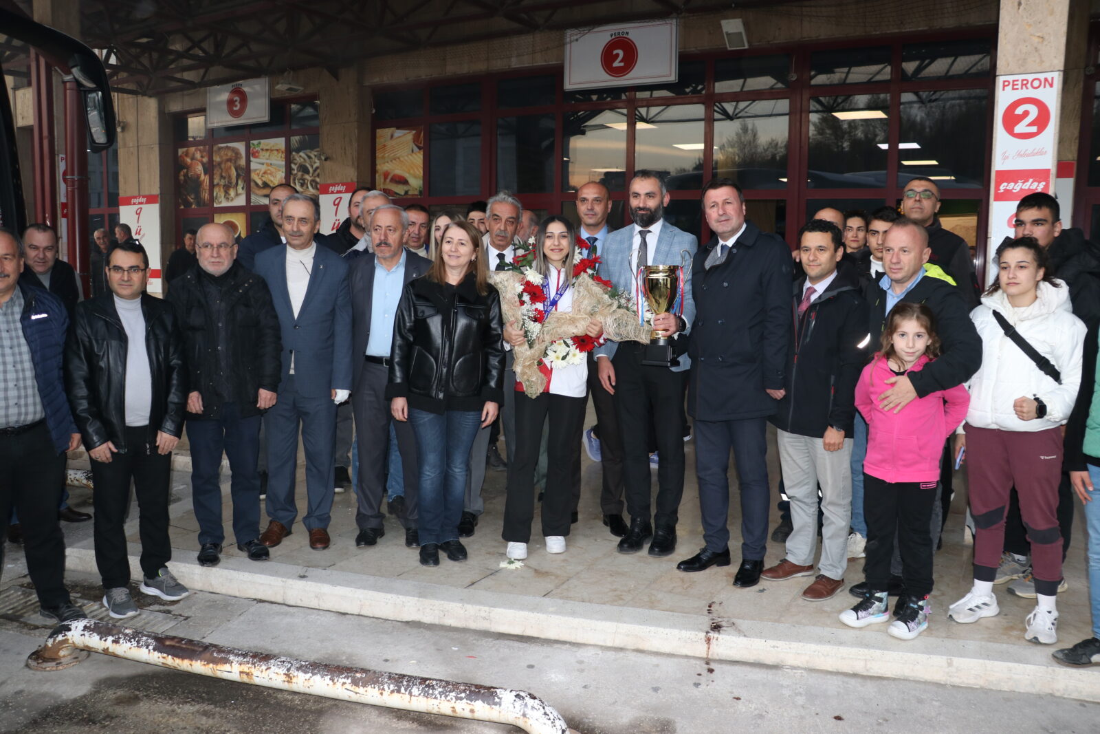 A welcome ceremony was held at Kastamonu Bus Terminal for Asuman Ciglioglu, who returned to her hometown after winning a gold medal at the European Kickboxing Championship in Greece, Kastamonu, Türkiye, Nov. 11, 2024. (AA Photo)