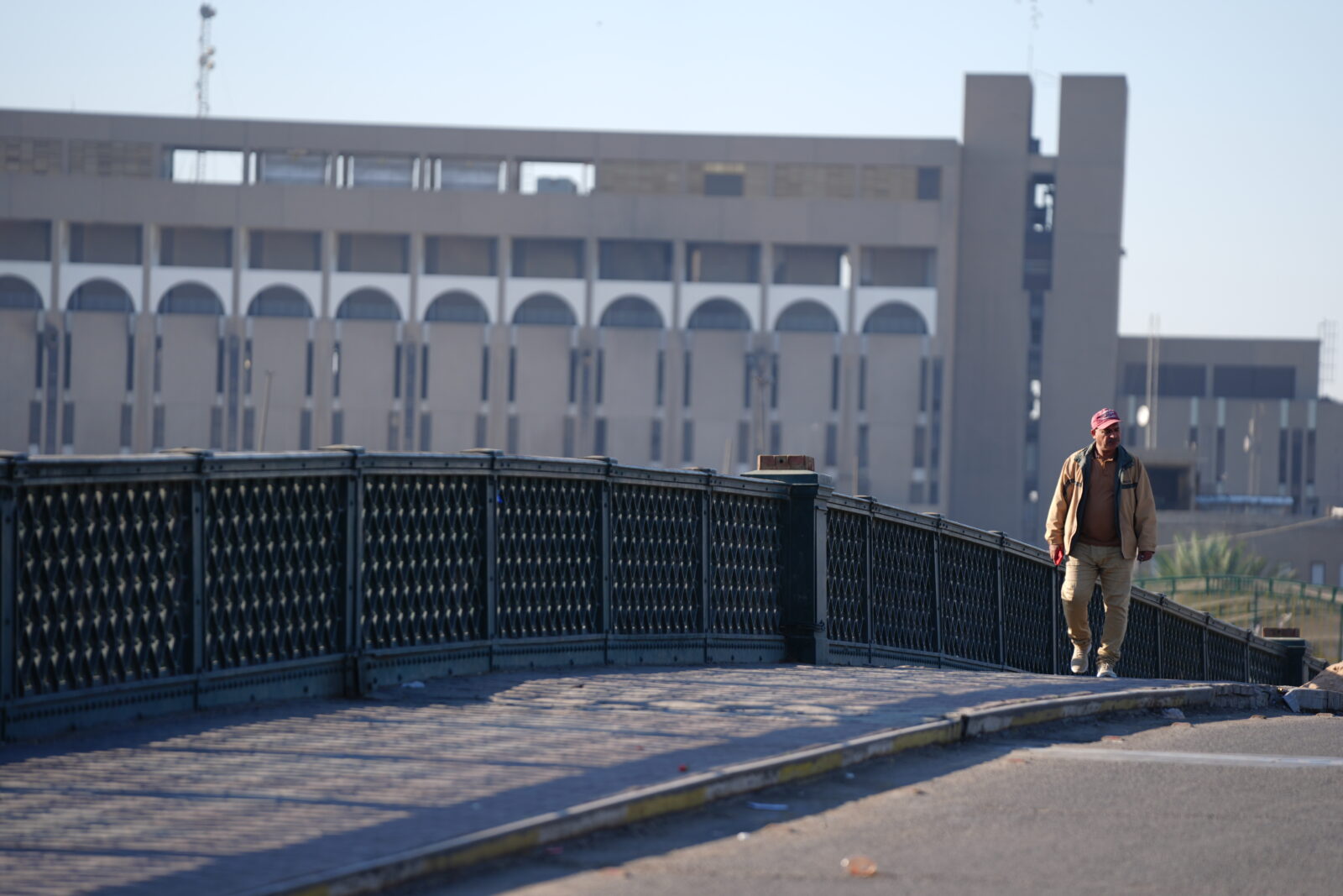 BAGHDAD, IRAQ - NOVEMBER 20: A man walks past an empty bridge as a two-day nationwide curfew was enforced for the first general population census after 27 years in Baghdad, Iraq on November 20, 2024. ( Murtadha Al-Sudani - Anadolu Agency )<img src=