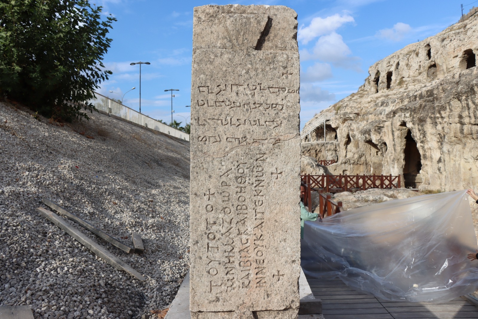 A tabula ansata (inscription tablet) with inscriptions in Greek and Aramaic found at the front of a burial chamber bearing the Jesus Christ monogram during excavation and restoration work in the Kizilkoyun Necropolis area, home to 2,000-year-old rock tombs in Sanliurfa, Türkiye, November 29, 2024. (AA Photo)