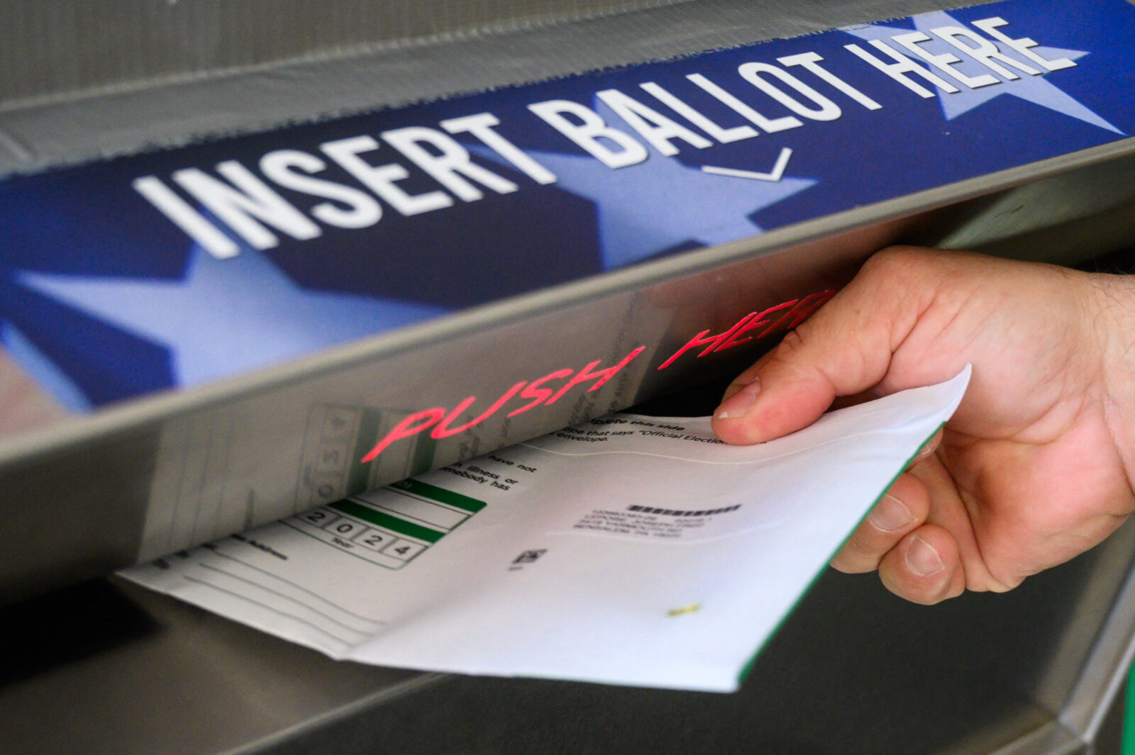 A voter uses a ballot drop box at the Bucks County Administration building voting on demand and ballot drop center in Doylestown, Pennsylvania on Oct. 31, 2024. (AFP Photo)