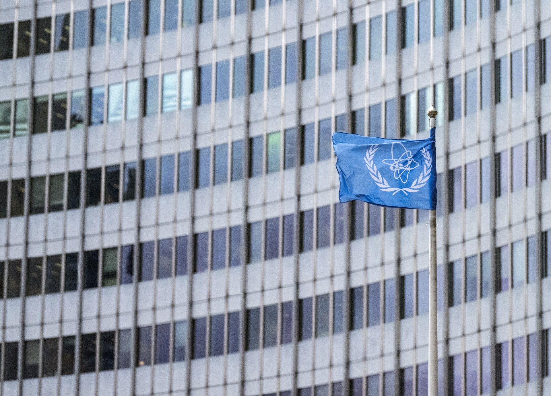 The IAEA flag flutters in the wind outside of the IAEA headquarters during the International Atomic Energy Agency IAEA's Board of Governors meeting at the agency's headquarters in Vienna, Austria, on November 20, 2024. - Western countries on November 20, 2024 formally submitted a new resolution critical of Iran at the International Atomic Energy Agency ahead of its board meeting, diplomatic sources said. (Photo by Joe Klamar / AFP)
