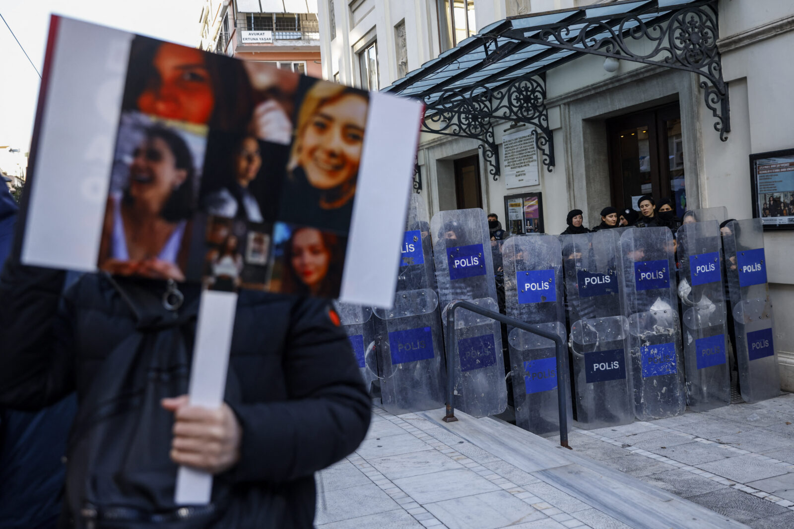 A protester holds portraits of Turkish women who were allegedly victims of violence, took part in a demonstration to mark the International Day for Elimination of Violence against Women, in Istanbul on Nov. 24, 2024. (AFP Photo)