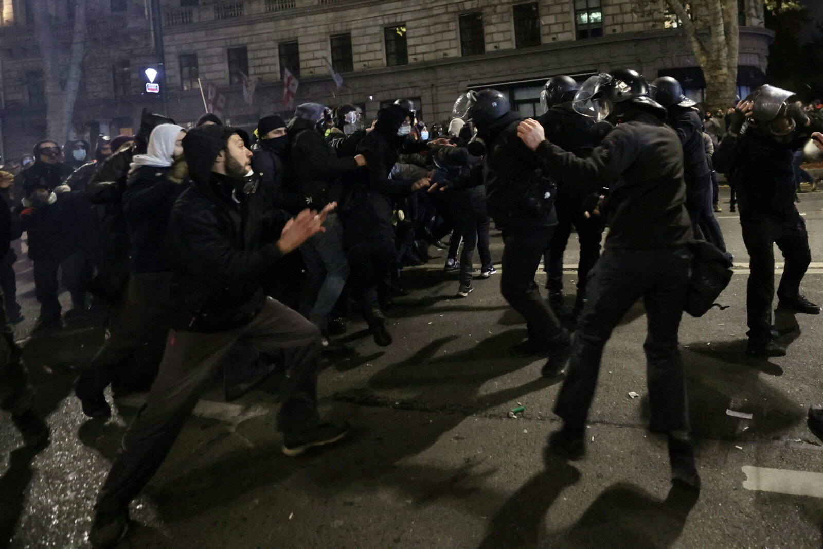 Protesters face off with police during a demonstration against the government's decision to delay EU membership talks, near the Parliament building in downtown Tbilisi early on Nov. 30, 2024. (AFP Photo)