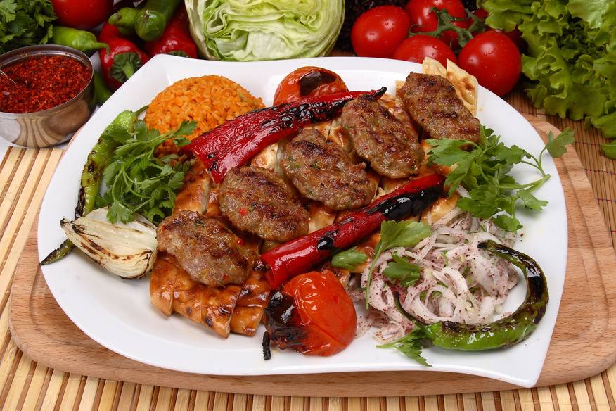 Turkish kofte served with grilled vegetables, flatbread, and bulgur—a classic dish with countless regional variations. (Adobe Stock Photo)
