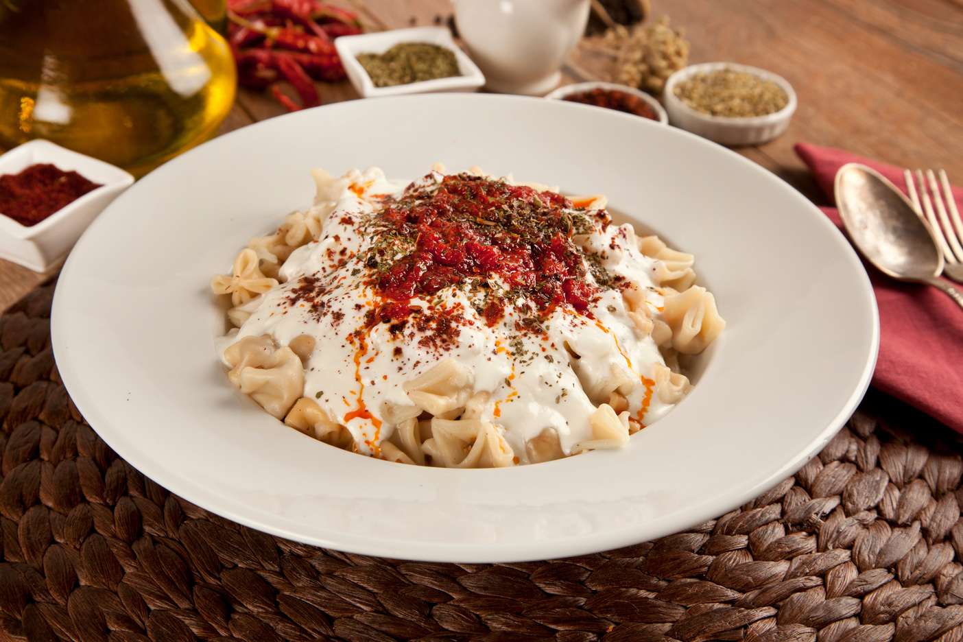 Traditional Turkish dumplings topped with garlic yogurt and a rich butter sauce infused with spices. (Adobe Stock Photo)