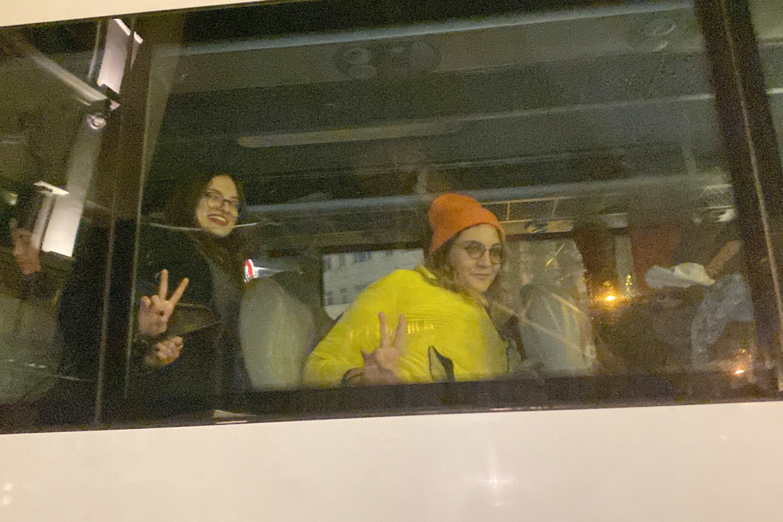 Two detained young women make peace signs while handcuffed with plastic restraints inside a police vehicle in Istanbul, Türkiye, Nov. 25, 2024. (Photo via X)
