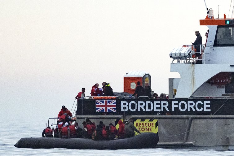 Migrants travel in an inflatable boat across the English Channel, bound for Dover on the south coast of England. (AFP Photo) 
