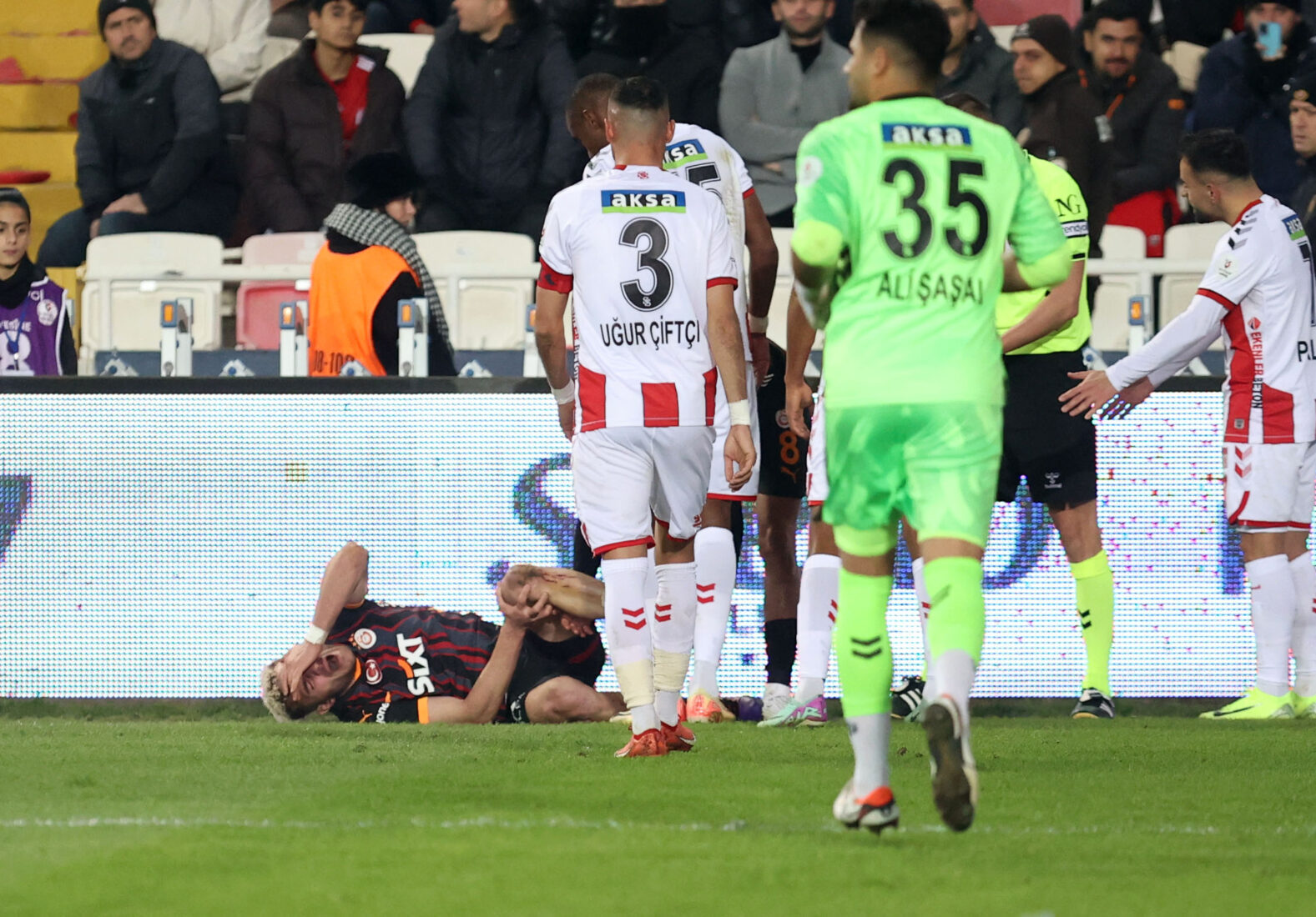 Baris Alper Yilmaz (ground) of Galatasaray gets injured during the Turkish Super Lig week 15 football match against Sivasspor in Sivas, Türkiye, Dec. 8, 2024. (AA Photo)