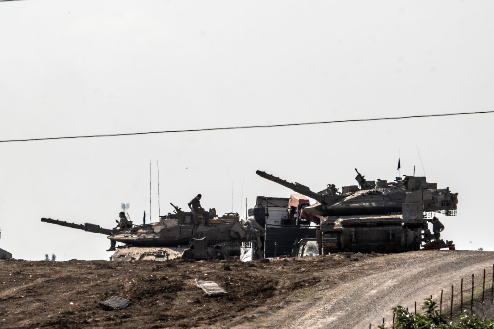 ISRAEL - DECEMBER 17: Israeli military vehicles are positioned near the Gaza border, as seen from Israel's Sderot and Kfar Aza on December 17, 2024. (AA Photo)Smoke rises from destroyed and heavily damaged residential areas in Gaza City following Israeli attacks, as seen from Israel's Sderot and Kfar Aza on December 17, 2024. (AA Photo)