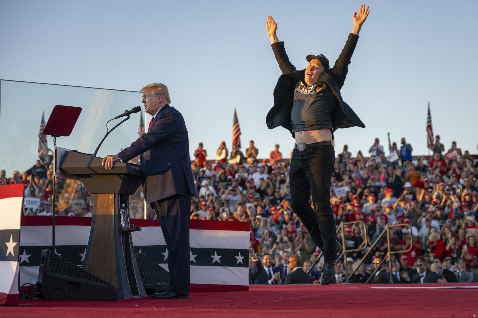 Tesla and SpaceX CEO Elon Musk (R) jumps on stage as he joins U.S. President Donald Trump (L) during a campaign rally at the site of the former President's first assassination attempt, in Butler, Pennsylvania on Oct. 5, 2024. (AFP Photo)