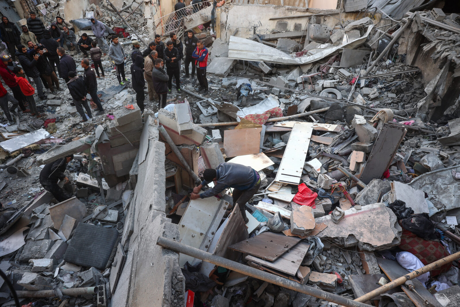 A man sifts through the rubble as others stand at the scene after an Israeli strike in Nuseirat in the central Gaza Strip on December 5, 2024, as the war between Israel and Hamas militants continues. (Photo by Eyad BABA / AFP)A Palestinian boy sits amid destruction as displaced residents return to Nuseirat in the central Gaza Strip after Israeli shelling stopped, Nov. 29, 2024. (AFP Photo)