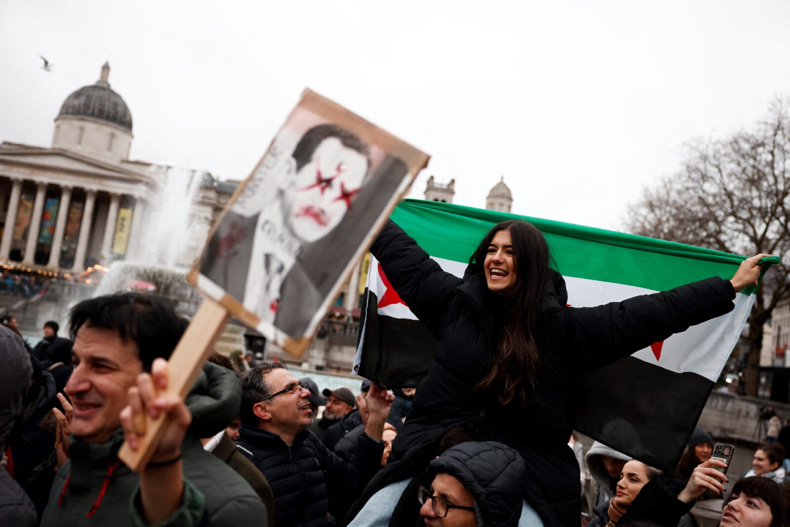 Supporters and members of Syrian community wave the Syrian opposition flag, also known as the revolution flag, in Trafalgar Square, central London, on December 8, 2024. (AFP Photo)