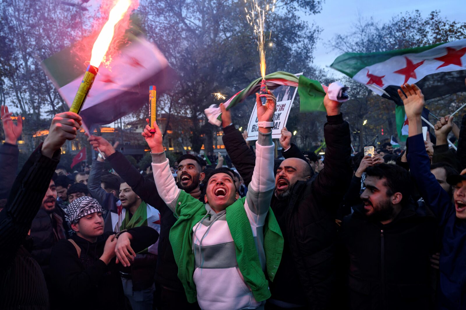 People hold Syrian opposition flags and flares as members of the Syrian community and supporters gather to celebrate the fall of Syrian president Bashar al-Assad, Istanbul, Türkiye, December 8, 2024. (AFP Photo)Syrians living in Istanbul celebrate at the courtyard of the Fatih Mosque after the fall of Syrian president Bashar al-Assad, Türkiye, December 8, 2024. (AA Photo)People hold a banner featuring Turkish President Recep Tayyip Erdogan as members of the Syrian community and supporters gather to celebrate the fall of Assad regime, Istanbul, Türkiye, December 8, 2024. (AFP Photo)People hold a banner featuring Turkish President Recep Tayyip Erdogan as members of the Syrian community and supporters gather to celebrate the fall of Syrian president Bashar al-Assad in Istanbul on December 8, 2024. (AFP Photo)
