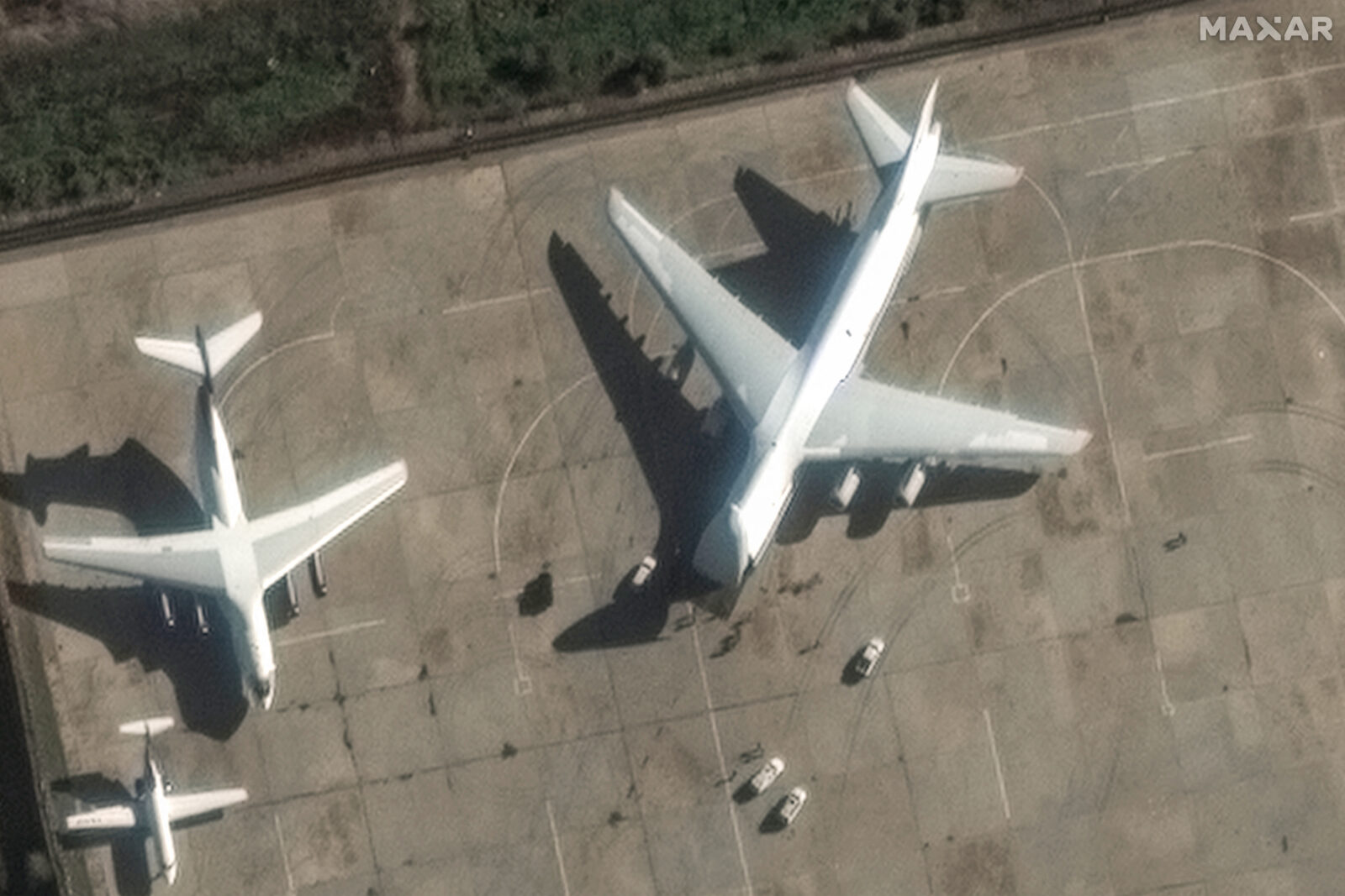 This handout satellite image released by Maxar Technologies on December 13, 2024 shows an Antonov An-124 heavy transport aircraft preparing to load equipment at the Russian Hmeimim Air Base in Syria's western province of Latakia. - Islamist-led rebels took the Syrian capital Damascus in a lightning offensive on December 8, ousting president Bashar al-Assad and ending five decades of Baath rule in the country. Assad was propped up by Russia, where he reportedly fled, as well as Iran and Lebanon's Hezbollah militant group. (Photo by Satellite image ©2024 Maxar Technologies / AFP) / RESTRICTED TO EDITORIAL USE - MANDATORY CREDIT 