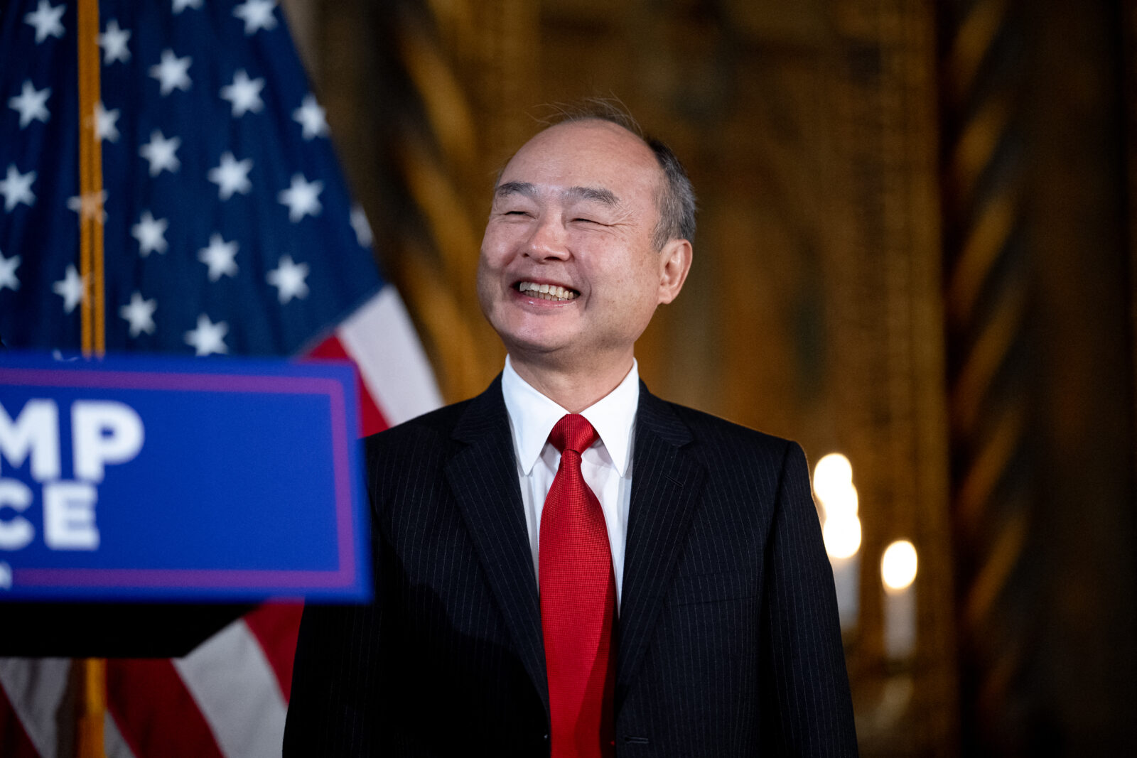 PALM BEACH, FLORIDA - DECEMBER 16: SoftBank CEO Masayoshi Son appears at a news conference with U.S. President-elect Donald Trump at Trump's Mar-a-Lago resort on December 16, 2024 in Palm Beach, Florida. In a news conference that went over an hour, Trump announced that SoftBank will invest over $100 billion in projects in the United States including 100,000 artificial intelligence related jobs and then took questions on Syria, Israel, Ukraine, the economy, cabinet picks, and many other topics. Andrew Harnik/Getty Images/AFP (Photo by Andrew Harnik / GETTY IMAGES NORTH AMERICA / Getty Images via AFP)PALM BEACH, FLORIDA - DECEMBER 16: U.S. President-elect Donald Trump looks on as SoftBank CEO Masayoshi Son delivers remarks at Trump?s Mar-a-Lago resort on December 16, 2024 in Palm Beach, Florida. Trump announced that SoftBank will invest over $100 billion in projects in the United States including 100,000 artificial intelligence related jobs. Andrew Harnik/Getty Images/AFP (Photo by Andrew Harnik / GETTY IMAGES NORTH AMERICA / Getty Images via AFP)