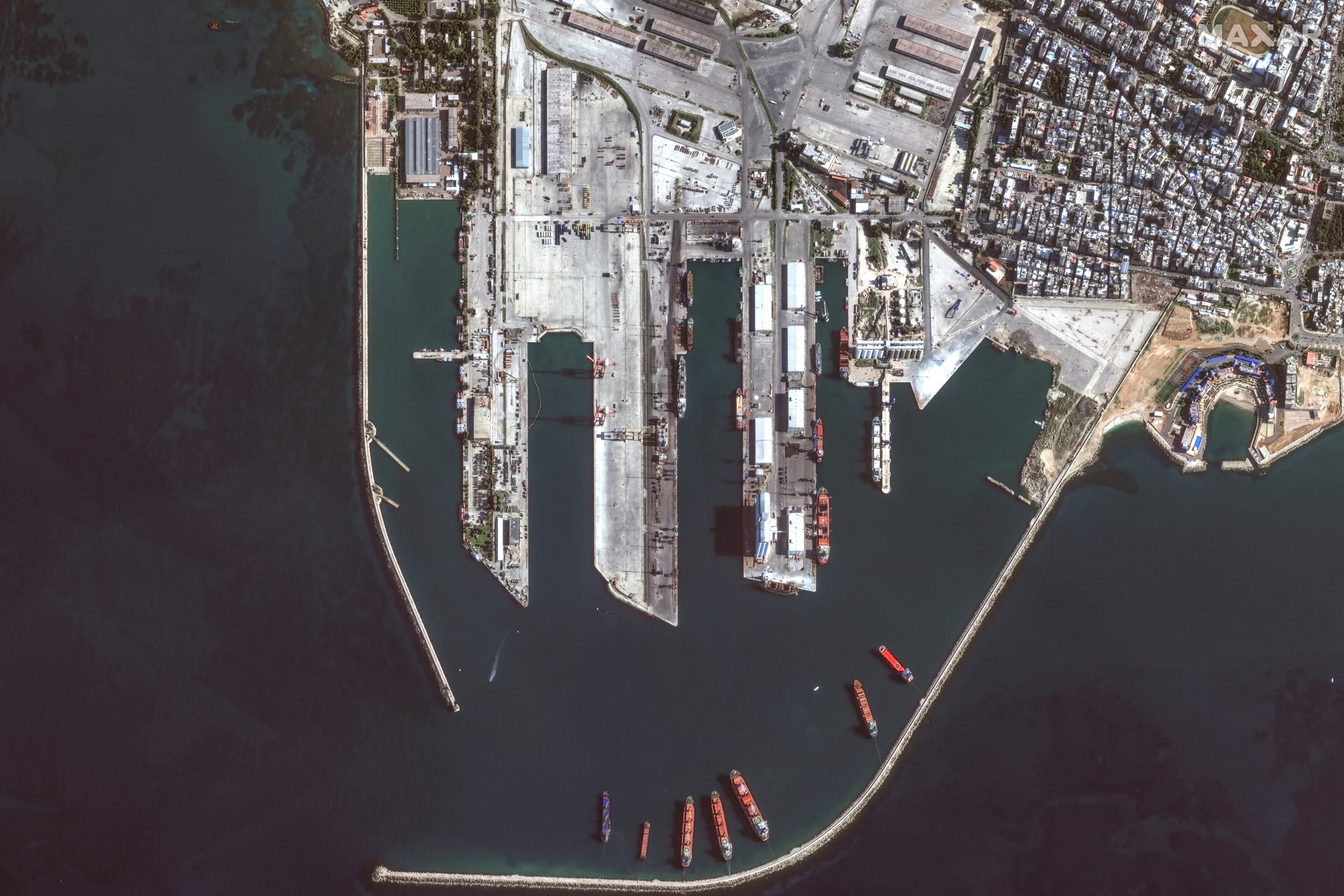 This handout satellite image taken by Maxar Technologies on December 17, 2024 shows an overview of the port of Tartus in western Syria. - Troops loyal to Syria's new interim government, led by the Islamist faction Hayat Tahrir al-Sham (HTS), now man the entrance gateway to the Tartus port, but they told AFP they were under orders not to approach the Russian forces, whose flag still flies over a military enclave in the terminal. The Tartus naval base and Hmeimim air base are Russia's only military outposts outside the former Soviet Union. (Photo by Satellite image ©2024 Maxar Technologies / AFP) / RESTRICTED TO EDITORIAL USE - MANDATORY CREDIT "AFP PHOTO/ SATELLITE IMAGE ©2024 MAXAR TECHNOLOGIES" - NO MARKETING NO ADVERTISING CAMPAIGNS - DISTRIBUTED AS A SERVICE TO CLIENTS - THE WATERMARK MAY NOT BE REMOVED/CROPPED
